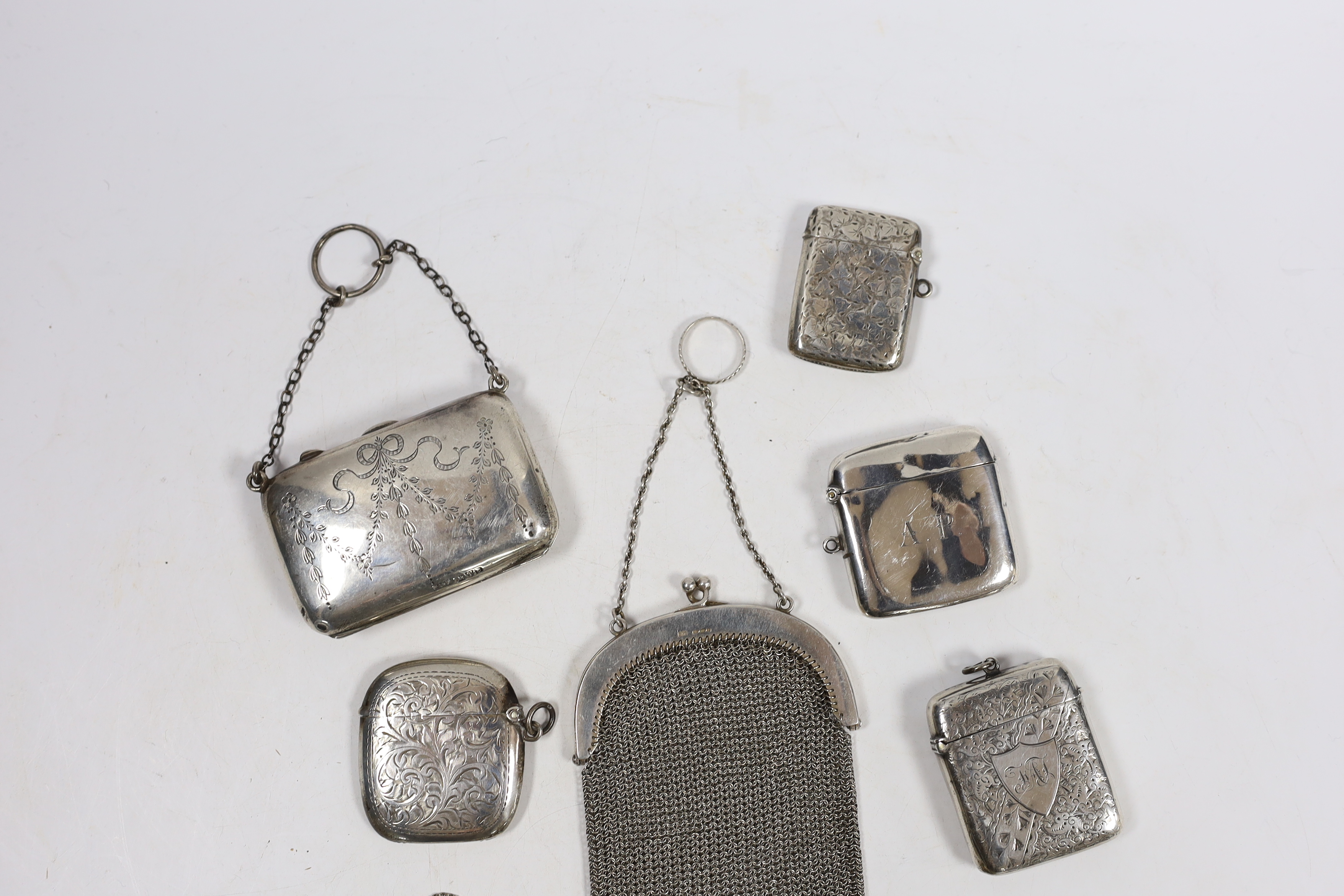 Four assorted early 20th century silver vesta cases and one base metal vesta case, two silver purses including mesh link and a small modern silver 'handbag' pill box.